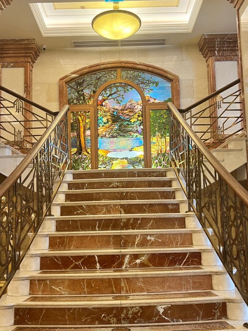 Marble staircase with stained-glass window.