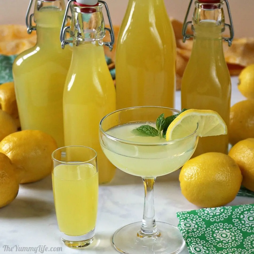 A table with lemons and glasses of lemonade.