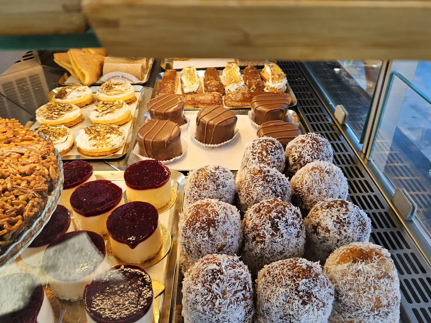 Assorted pastries in a bakery display case.