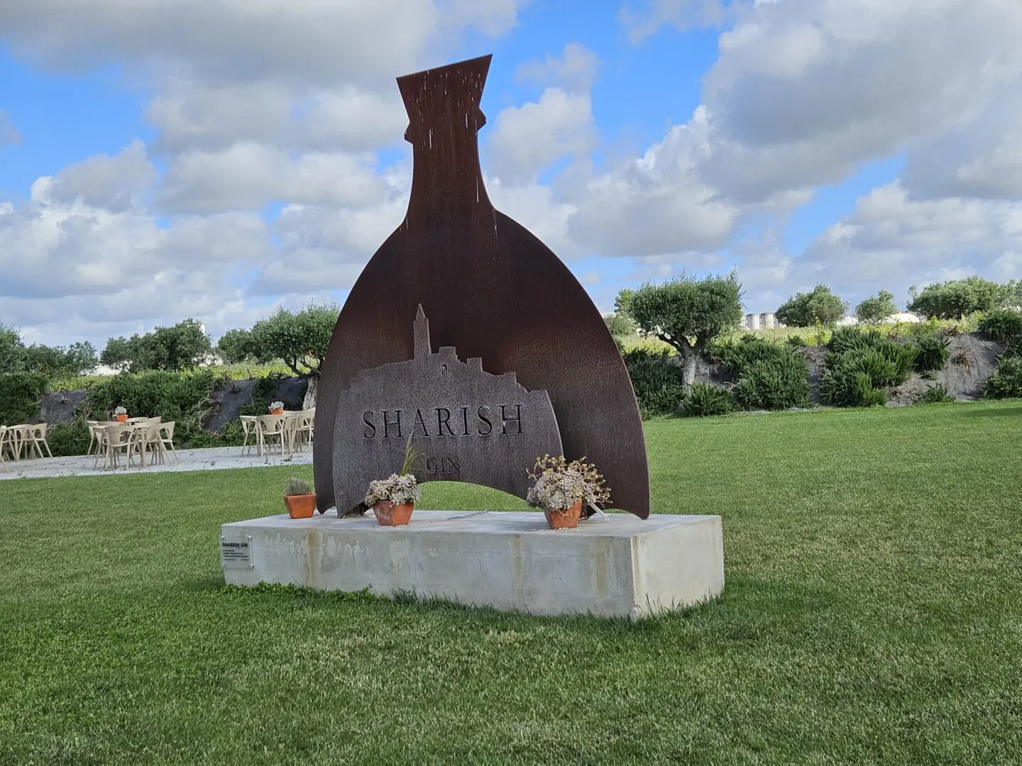 Metal sculpture of a gin bottle