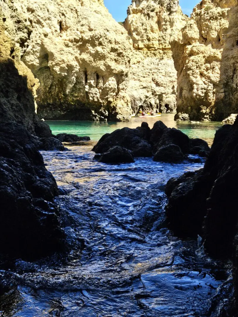 Rocky cliffs with calm blue water.