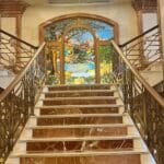 Grand marble staircase with stained glass.