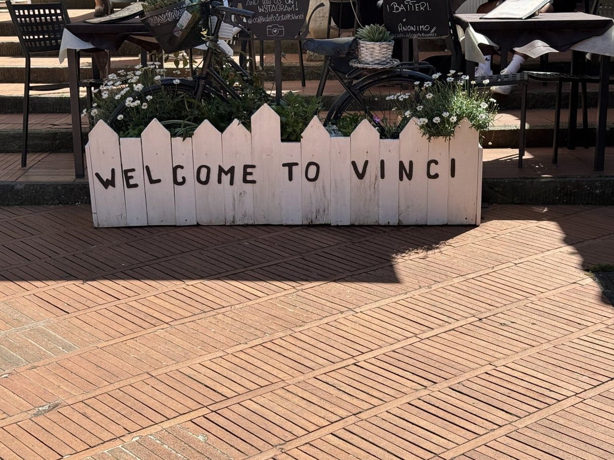 Colorful welcome sign with various country flags.