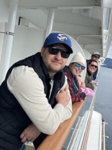 People smiling on a cruise ship deck.
