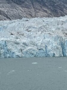 Glacier meeting the ocean, rugged icy landscape.