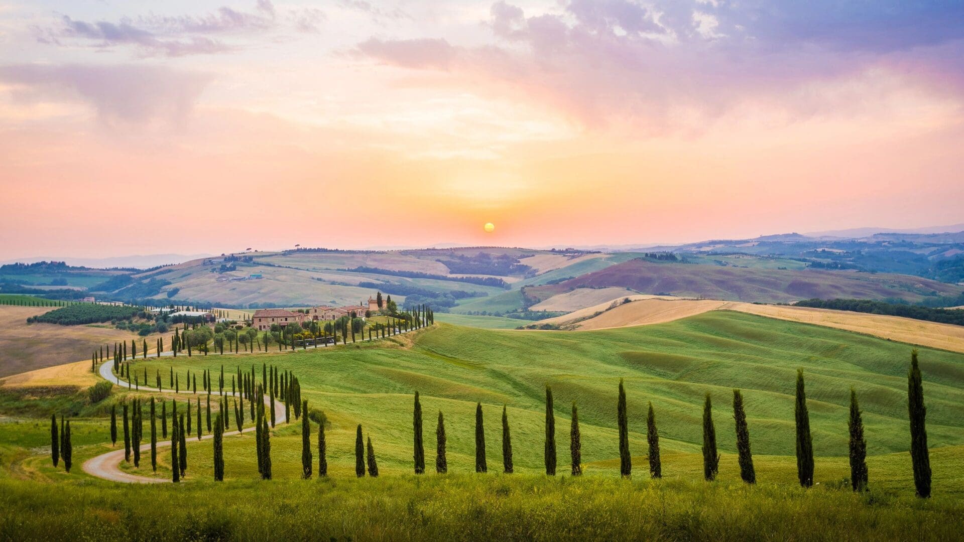 Tuscan countryside with rolling hills and vineyards.